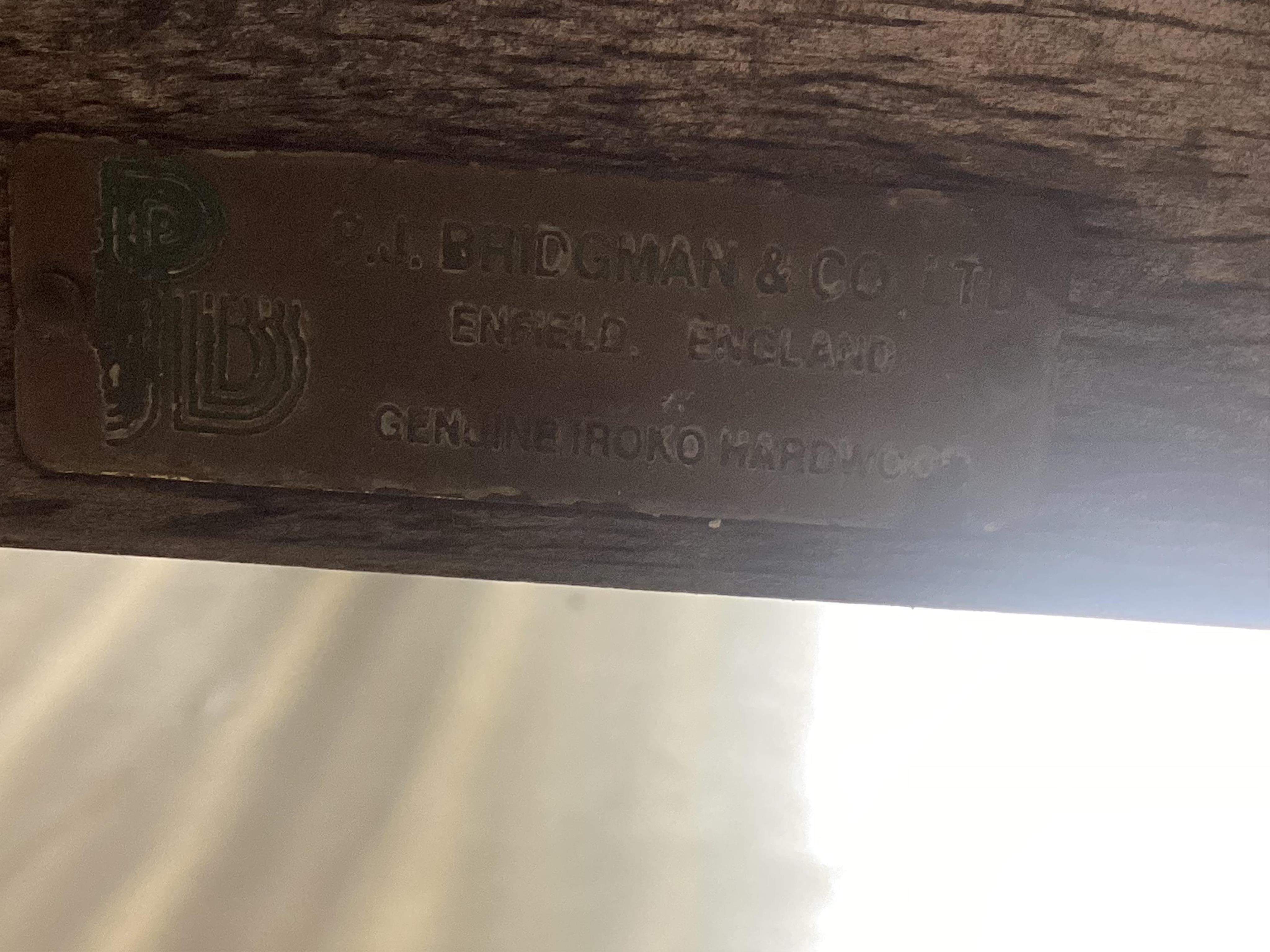 A vintage Bridgman & Co iroko hardwood garden bench, width 184cm, depth 51cm, height 90cm. Condition - fair